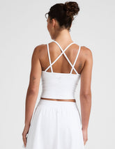 white waist length, V neckline tank top with a self shelf bra and criss-cross strap back detail.